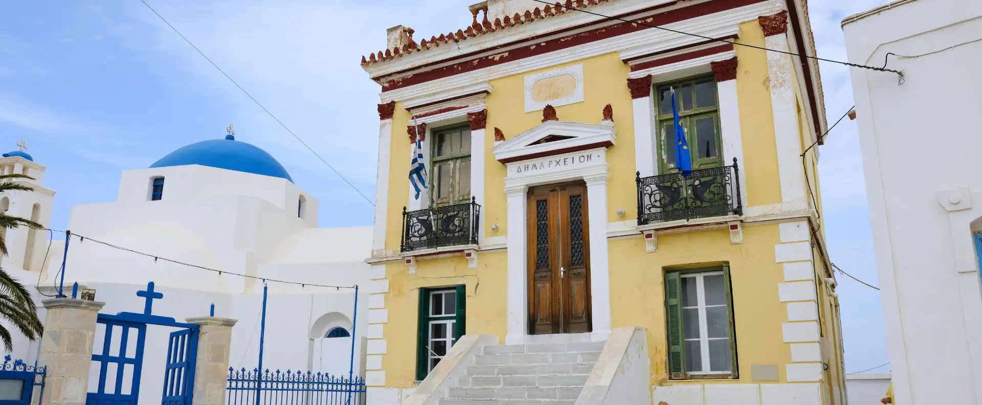 Historic town hall and blue-domed church in Serifos, a cultural gem on small ship cruises
