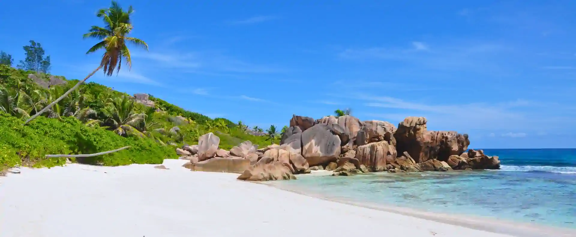 Iconic granite boulders and white-sand beach in La Digue, seen during a Seychelles cruise