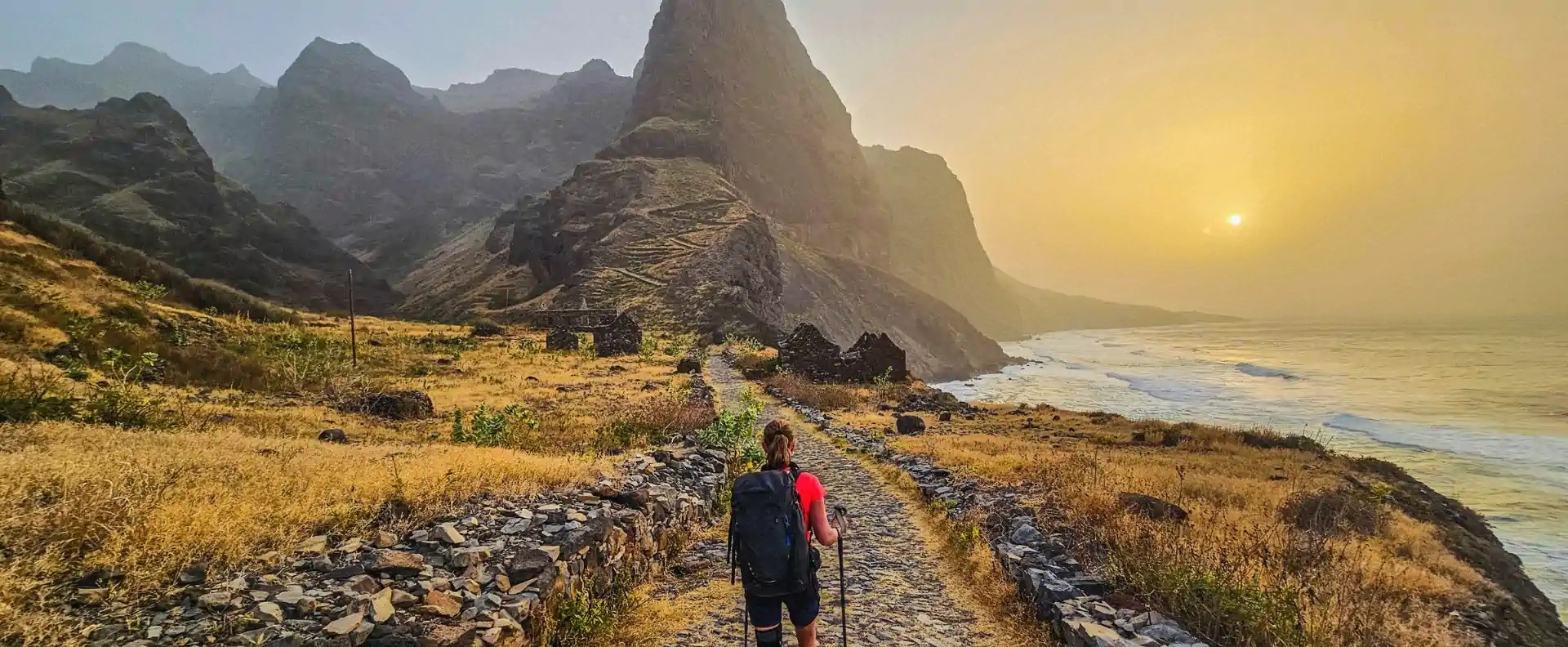 cruise cape verde santo antao hiking trail Hiker walking a coastal trail at sunset on Santo Antão island, Cape Verde