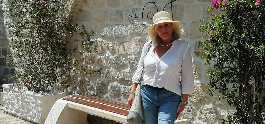Panoramic sunset view of Mykonos with a traditional white windmill overlooking the town and harbour