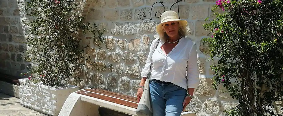 Panoramic sunset view of Mykonos with a traditional white windmill overlooking the town and harbour