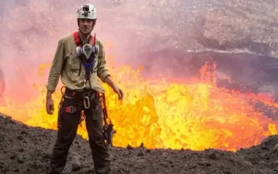 Untitled Aeolian Islands Cruise host George Kourounis standing near an active lava flow, wearing safety gear.