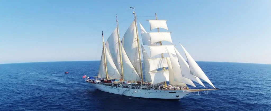 A tall ship cruising under full sail