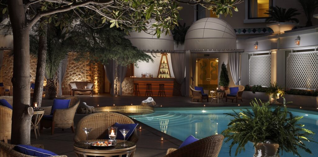Pool bar at night at the Royal Olympic Hotel