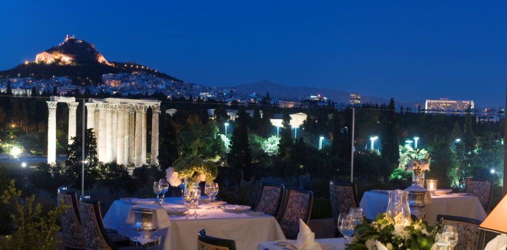 Roof garden at night overlooking the Temple of Olympian Zeus and Lycabettus Hill
