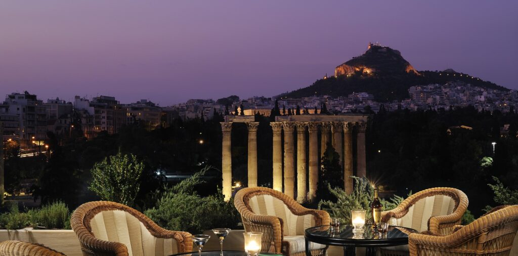 Terrace view of the Temple of Olympian Zeus and Lycabettus Hill at dusk
