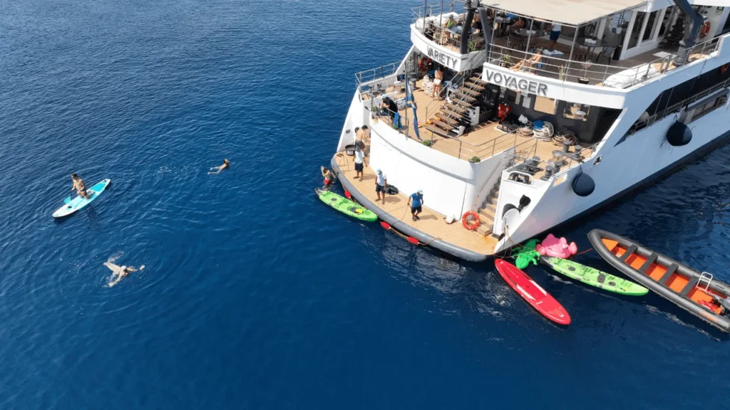 Kayaks and paddleboards beside Variety Voyager